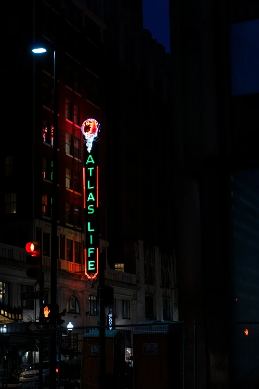 a traffic light that is lit up by neon lights