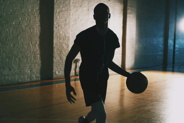 a man is walking around with a basketball in hand