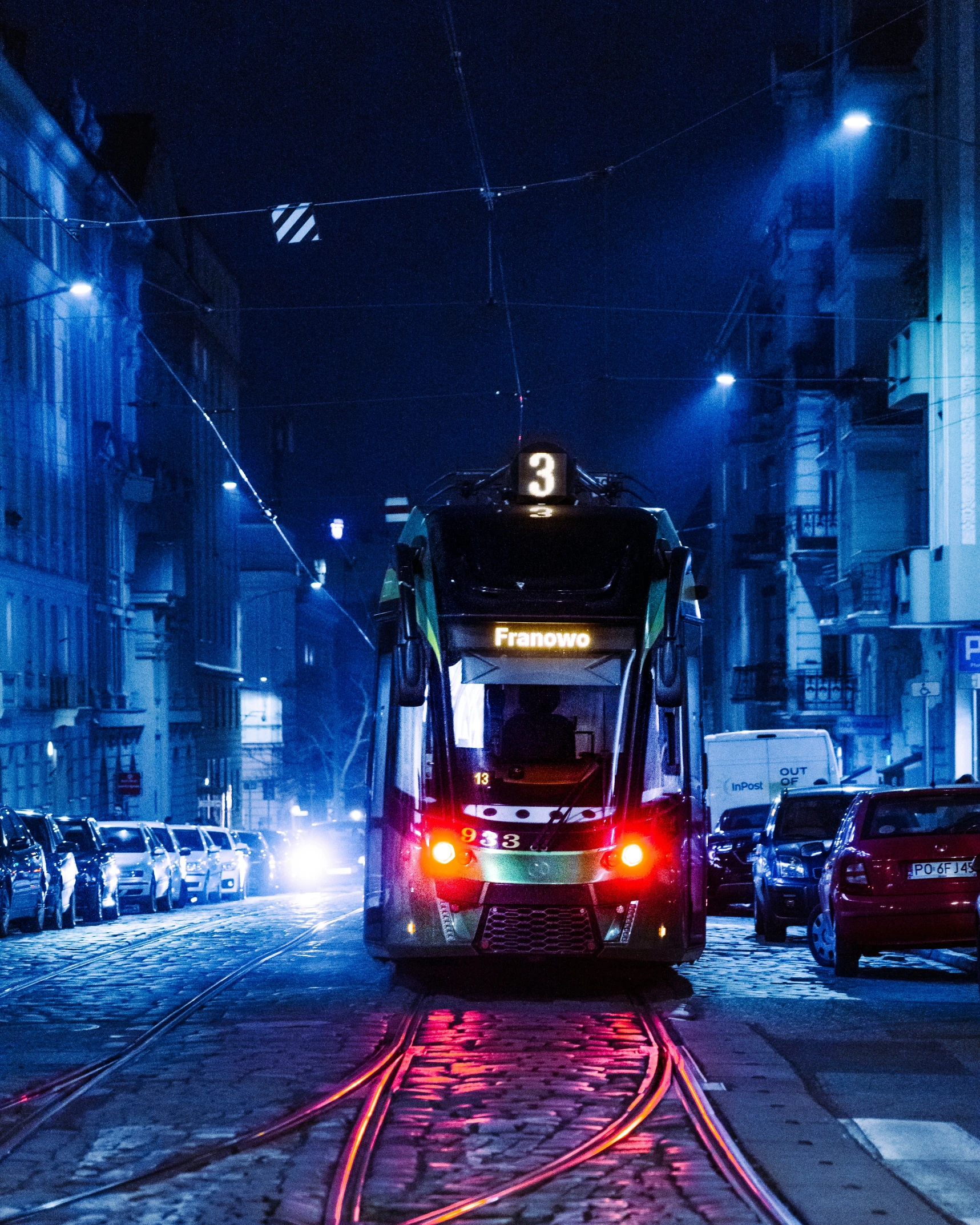 bus in a street that is next to a building