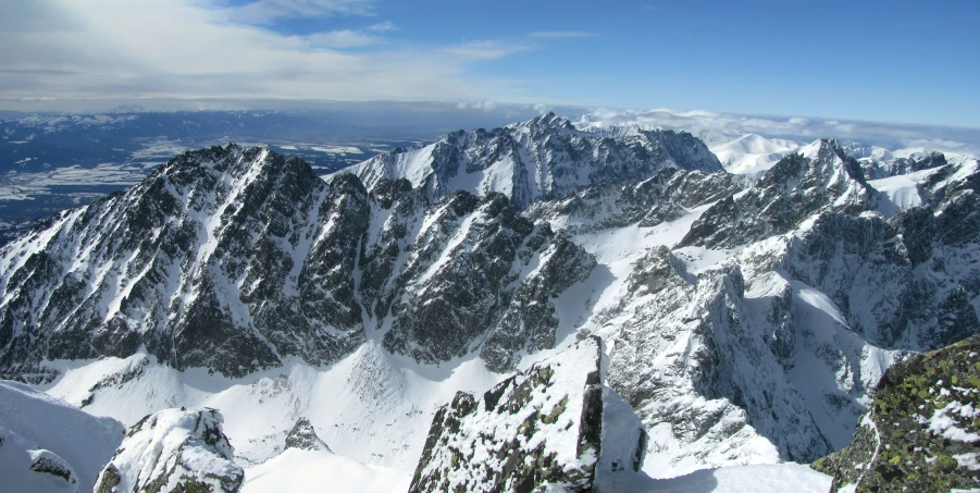 a view from an airplane looking at a mountain covered in snow