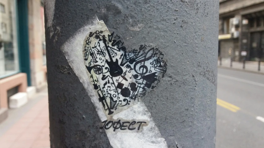 a heart shaped piece is painted on the street pole