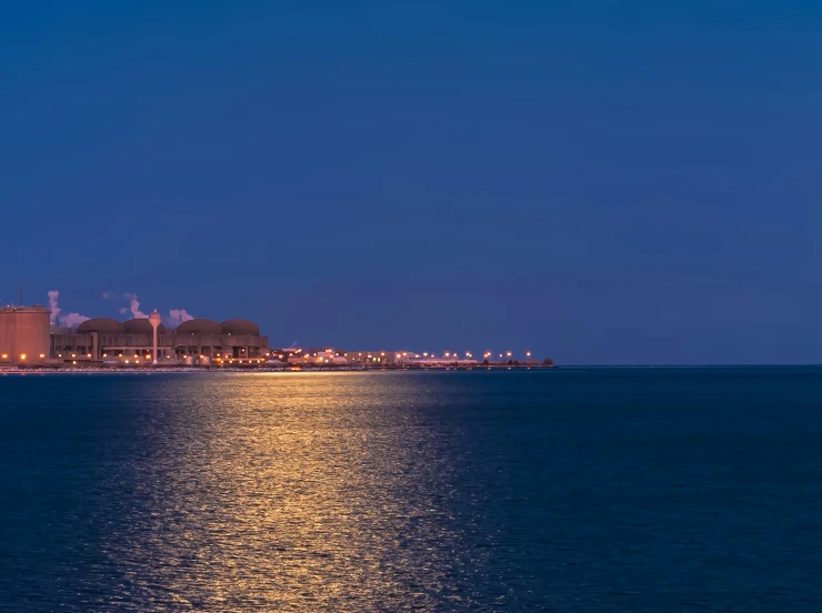 a bright blue sky and water at night