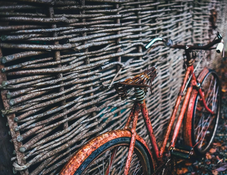 two bikes  up to a wall by a brick structure