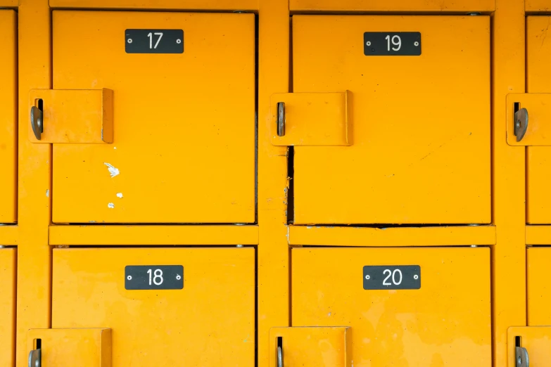 a close up of yellow lockers with numbers on them