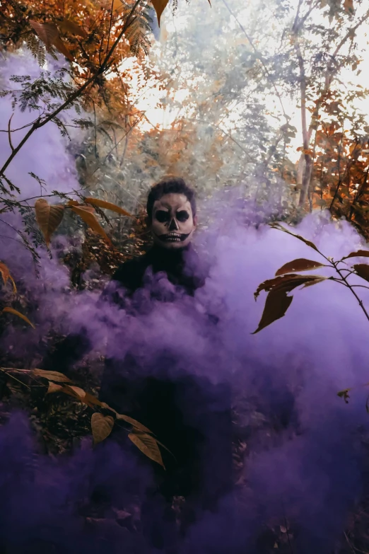 a man dressed in a halloween costume surrounded by smoke