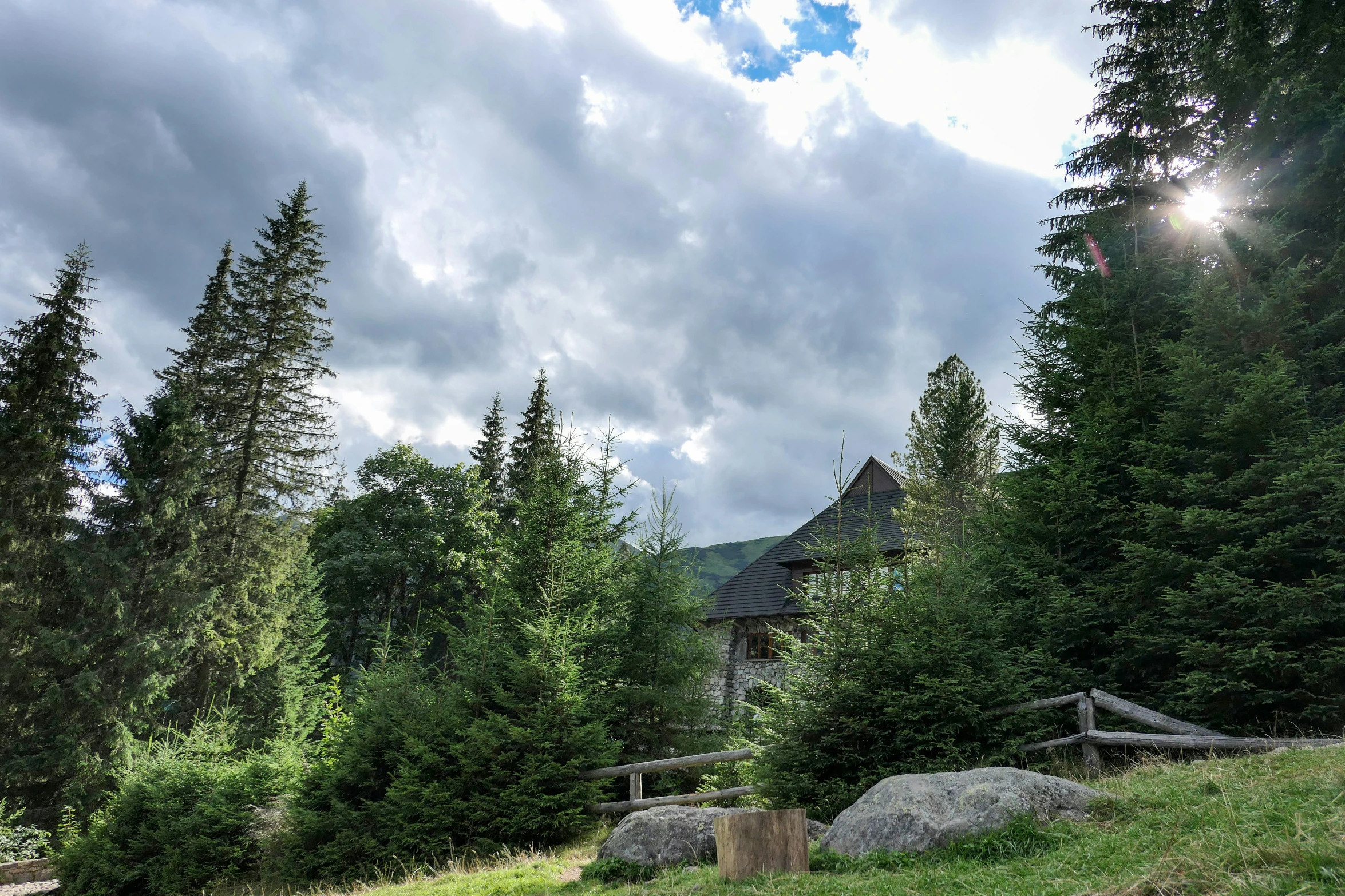 the house in the distance with dark clouds above