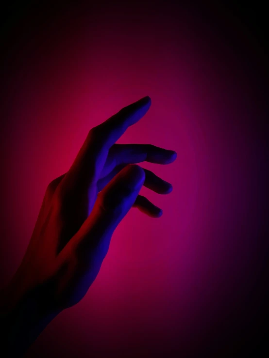 a purple and blue hand is casting a shadow