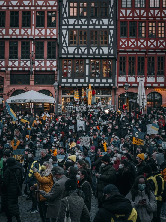 the people are celeting next to the large building