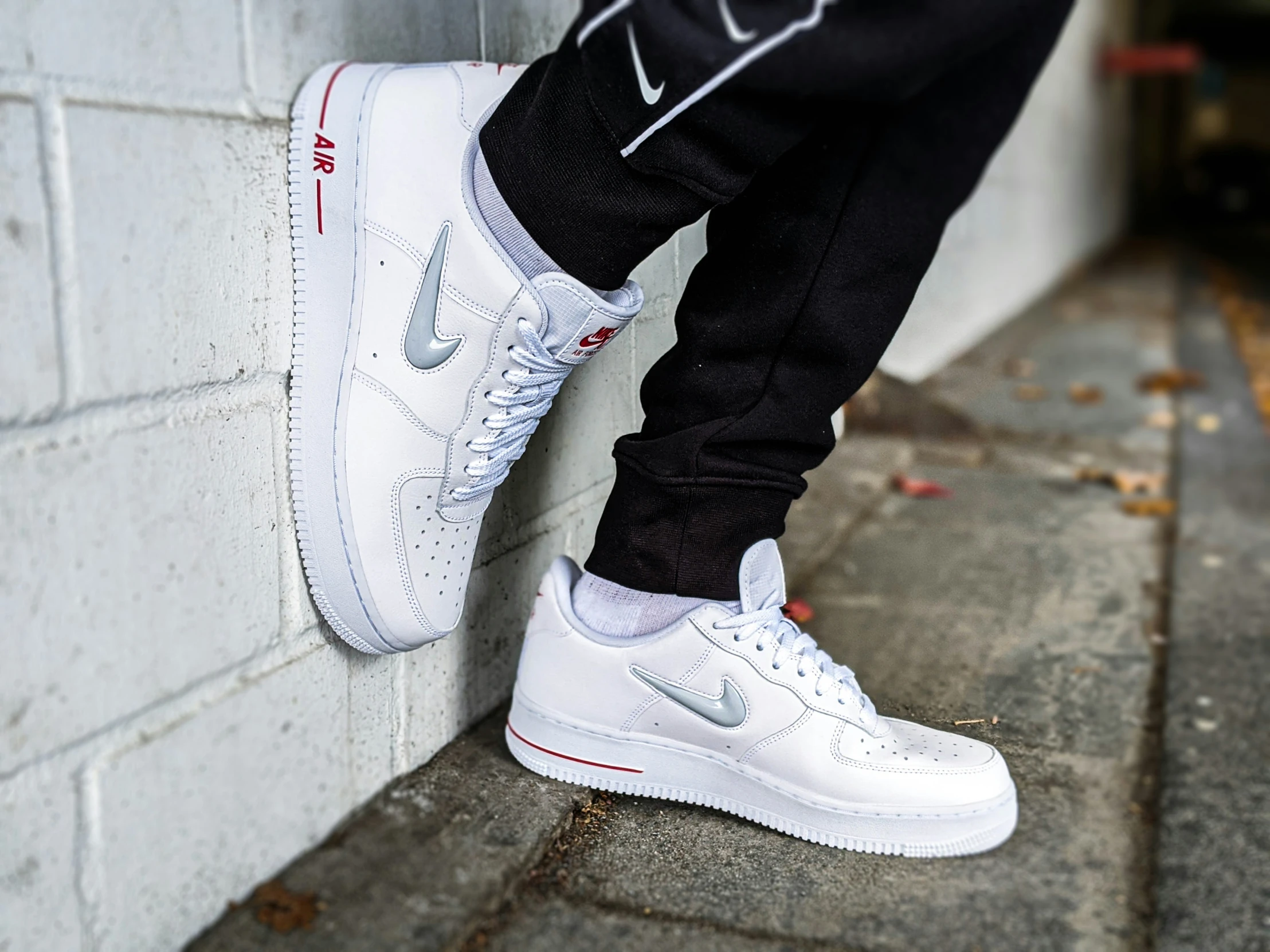 someone wearing a white and black nike air force sneakers