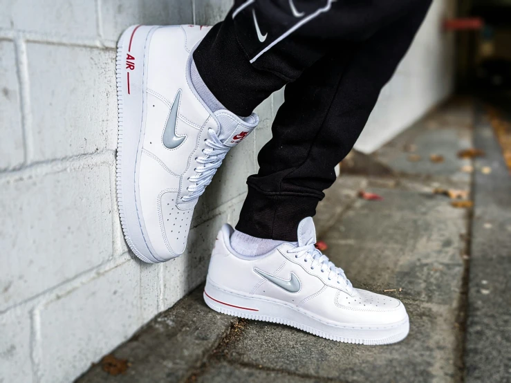 someone wearing a white and black nike air force sneakers
