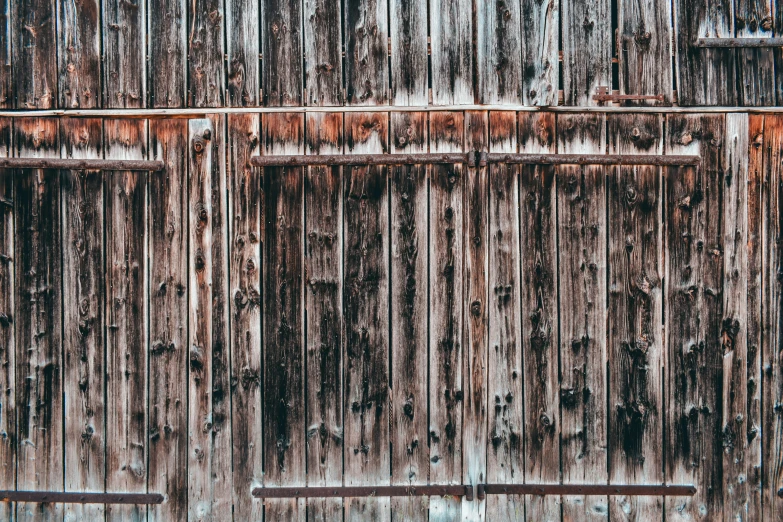 the brown wall has horizontal bars to protect it from the rain