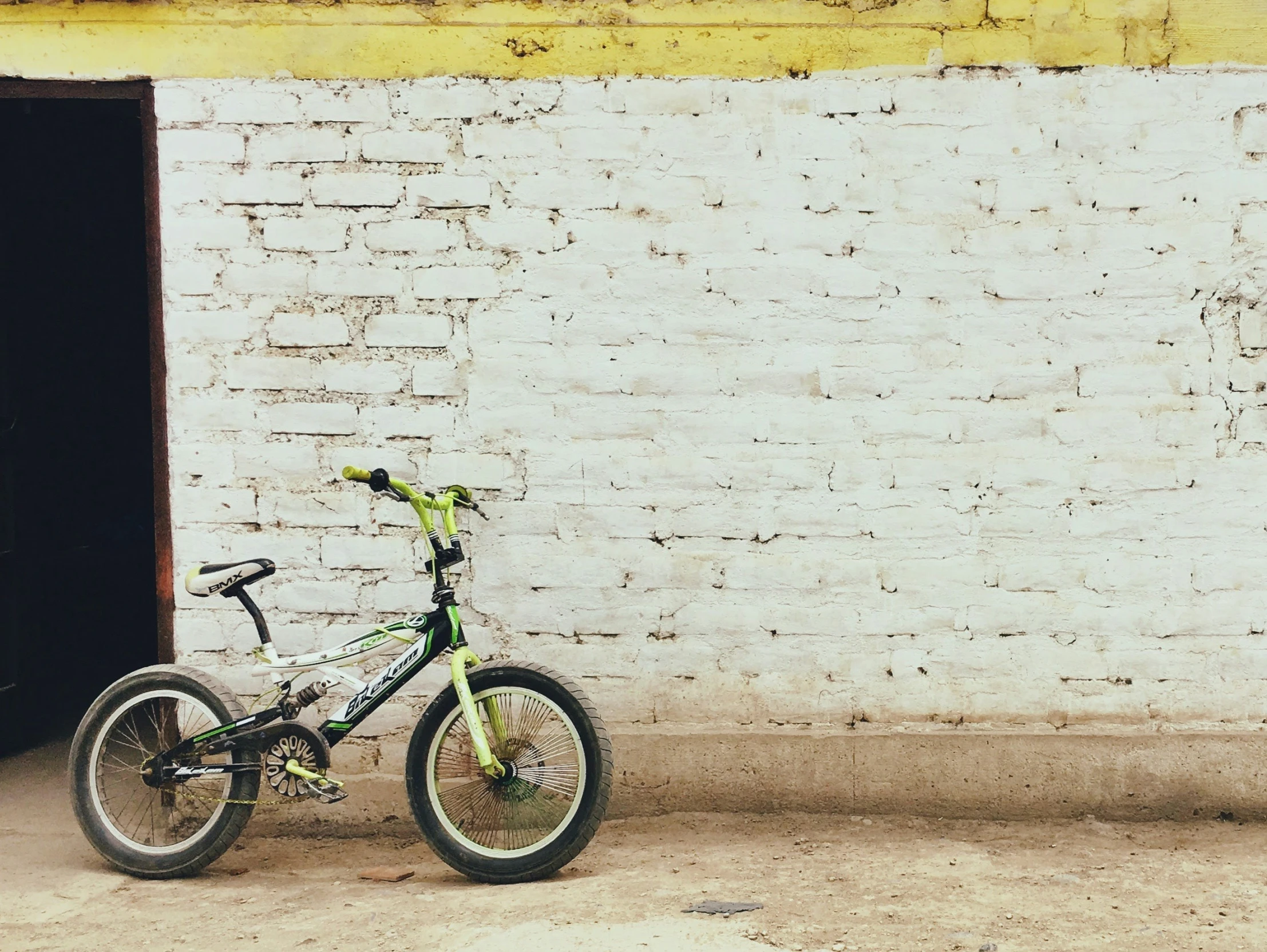 a bicycle parked outside a building that has no doors