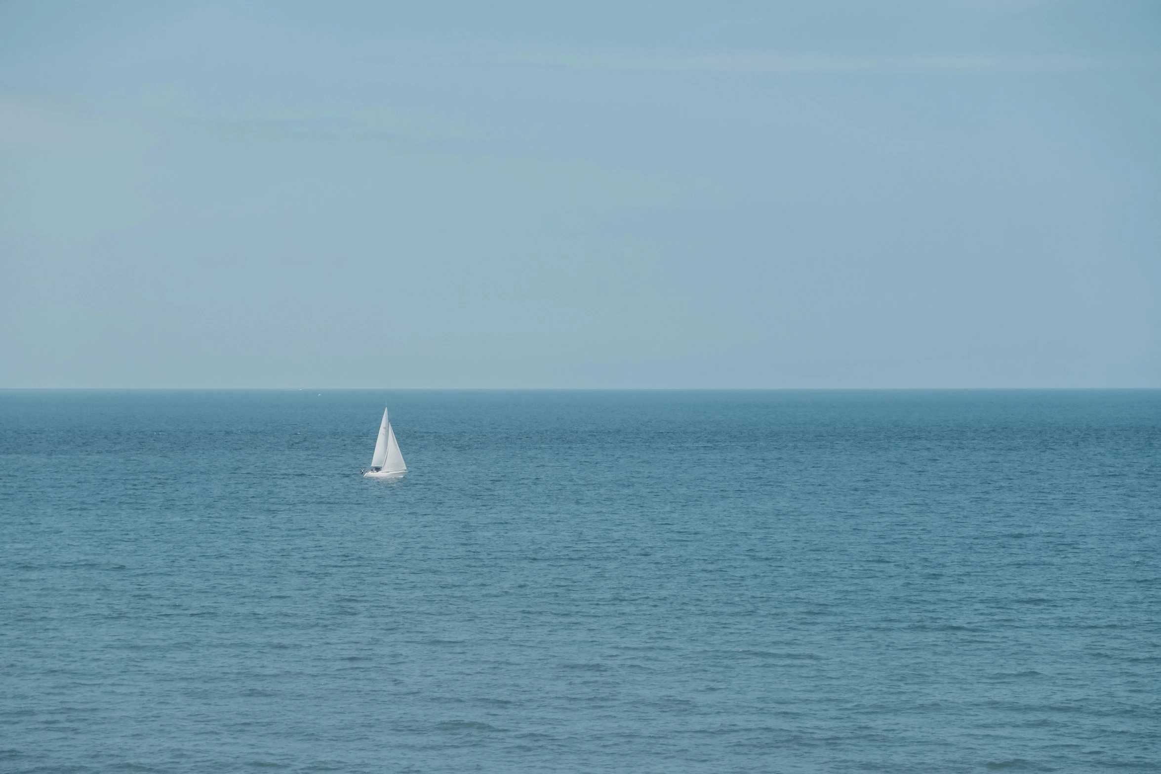 a sailboat is sailing across the ocean