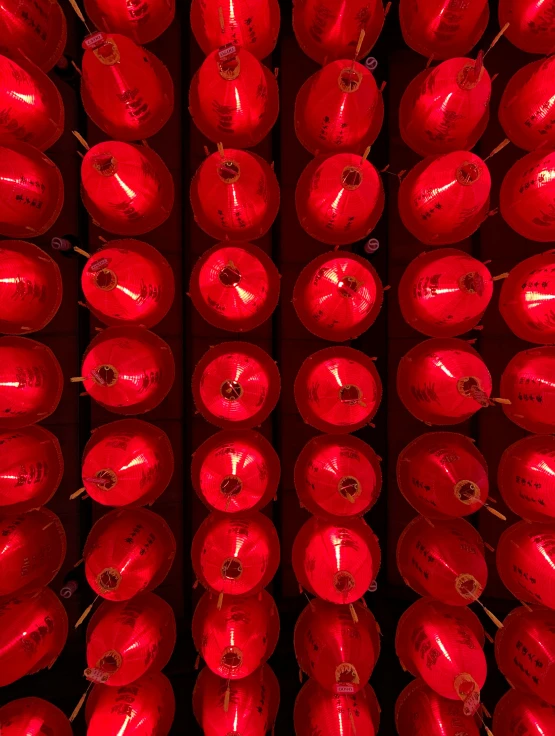 several rows of bright red lanterns with lights