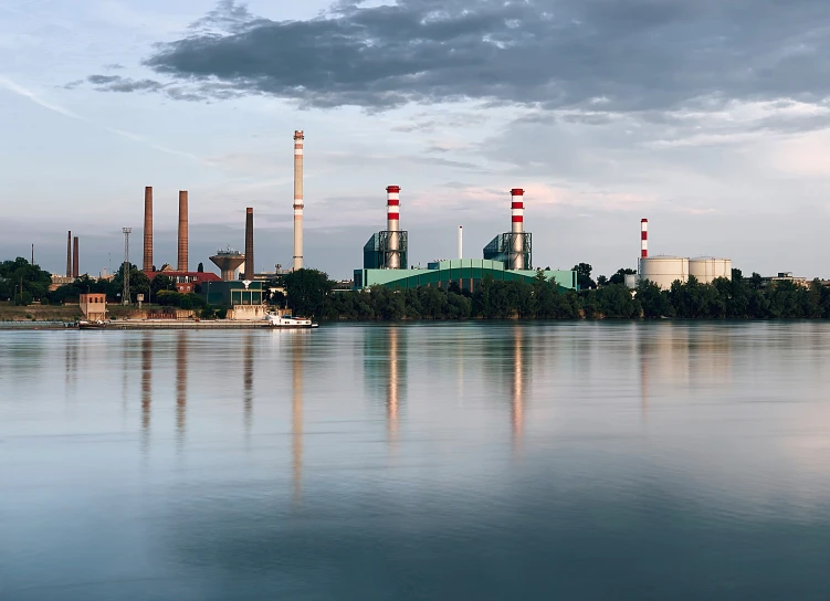 some kind of factory on a hill by the water