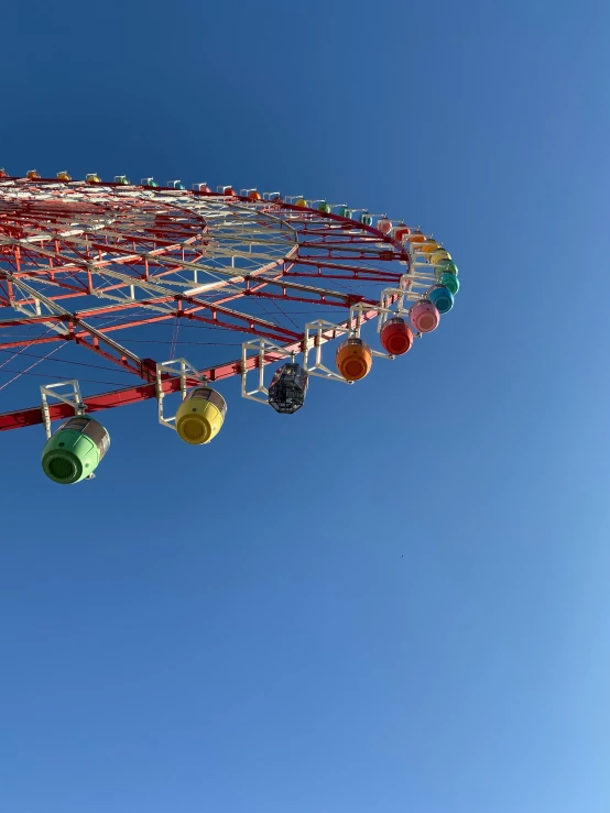 a colorful fair ride wheel with colored balls attached