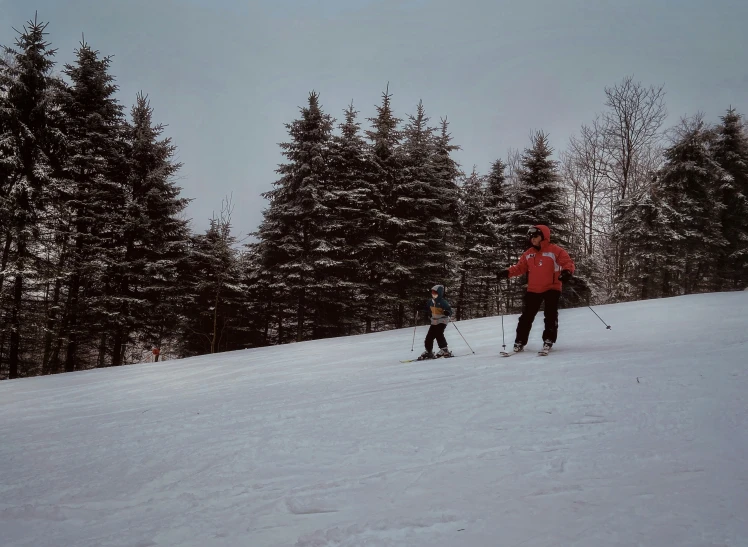 a group of skiers are traveling along the slope