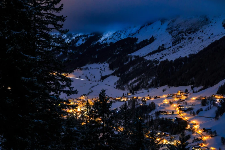 a snowy mountain town lit up at night