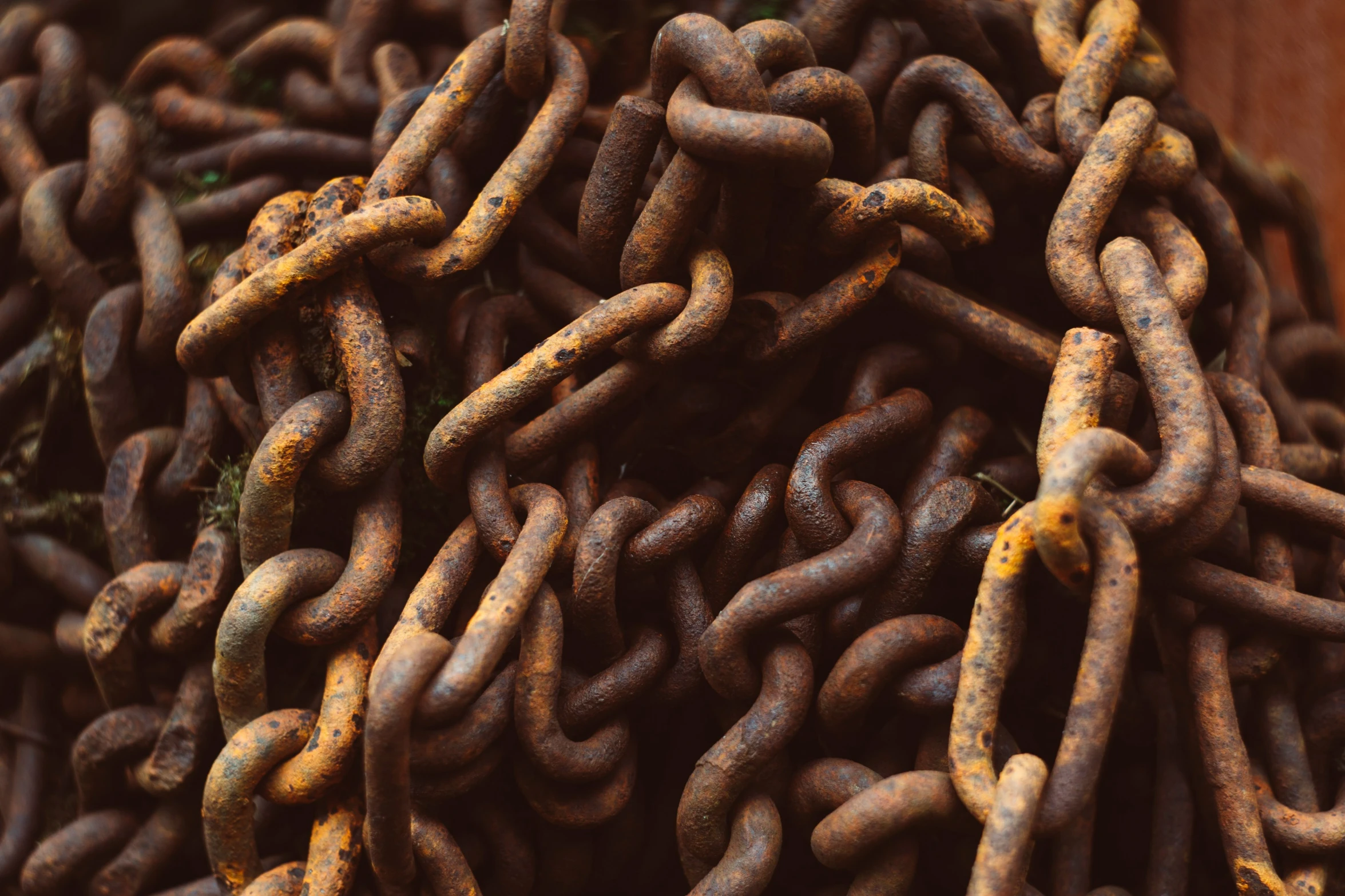 an old large, rusty chain is piled up