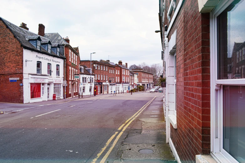 the city has empty sidewalks on both sides of the streets