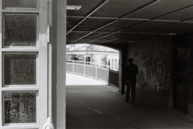 man walking into tunnel through dirty tunnel