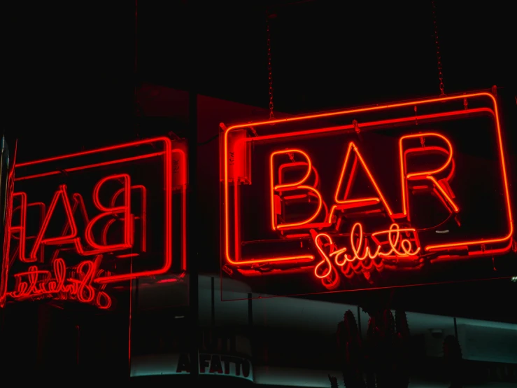 a neon sign hanging from the side of a building