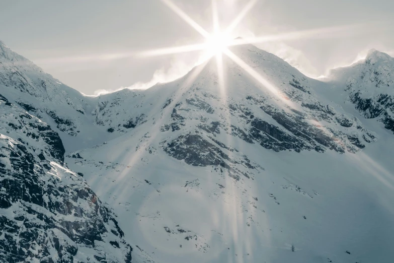 a skier doing a jump in front of a snowy mountain