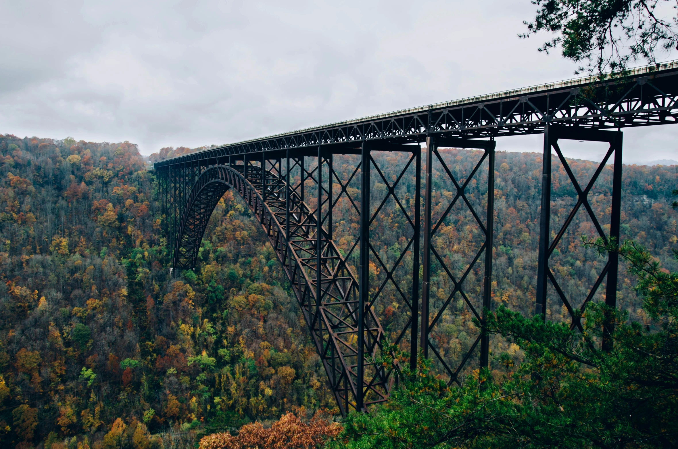 the blue train is going on the train bridge