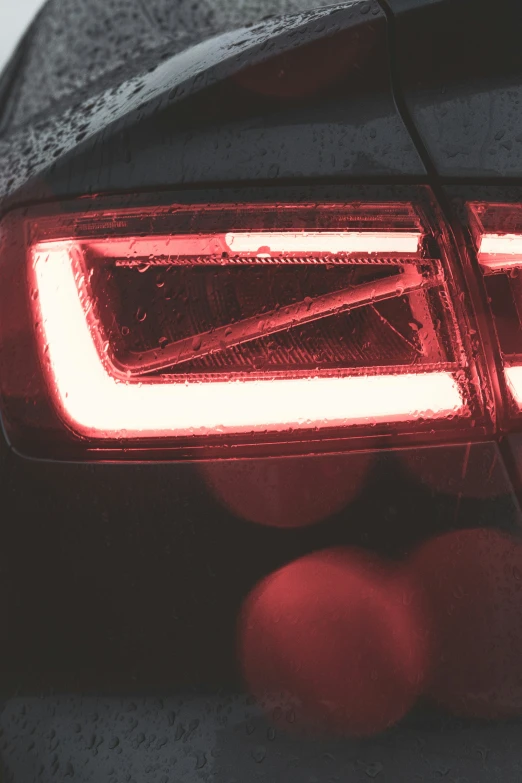 a car's tail light with red ball underneath it