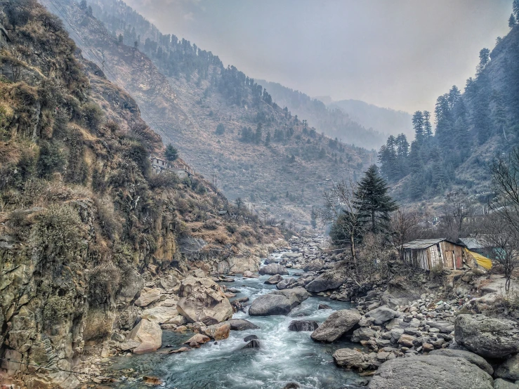 a river in the mountains that is flowing