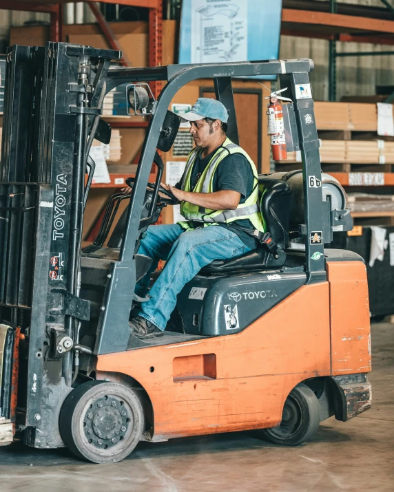 man in a fork lift in an empty warehouse