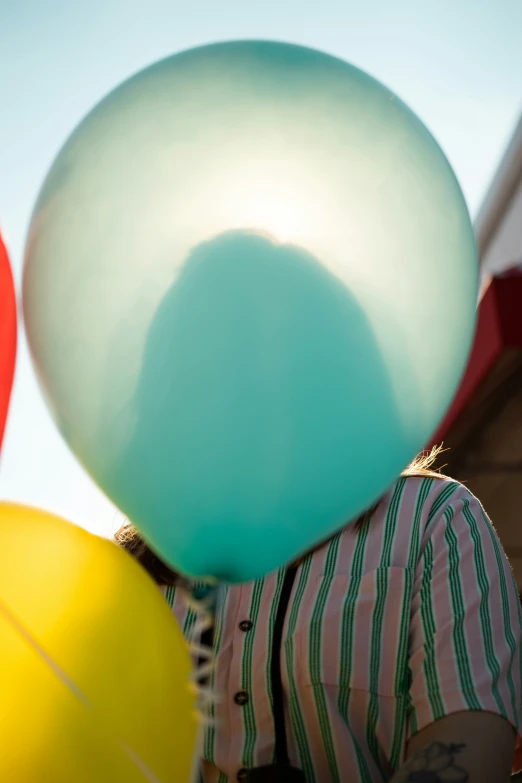 a person holding balloons in their hands