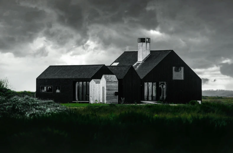 a house with the front view showing dark clouds behind it