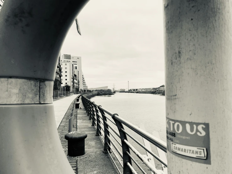 a black and white view of some buildings near water