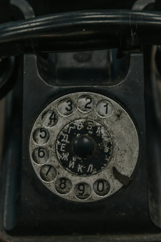 an old, rusty telephone thats missing the dial