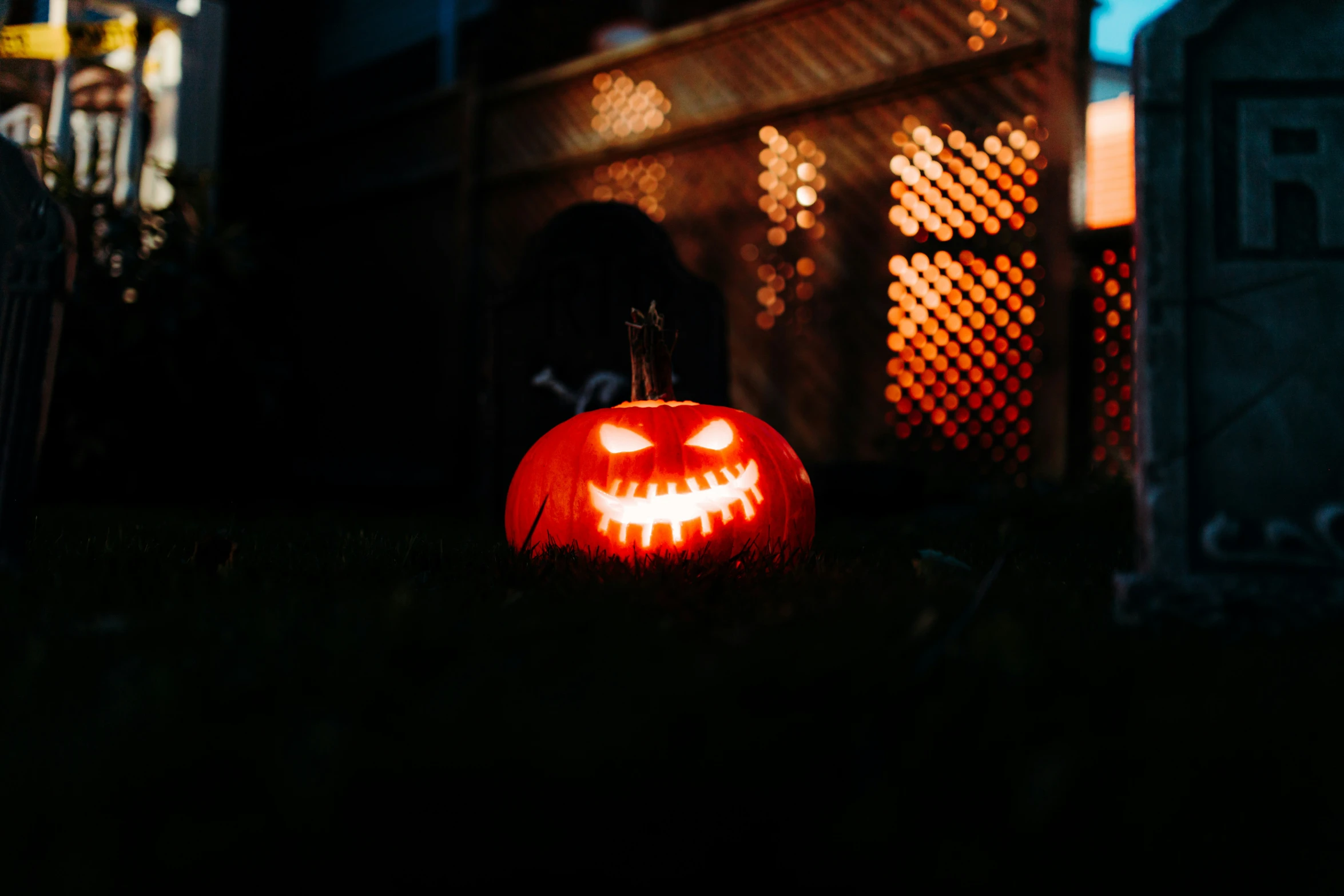 a carved pumpkin sitting in the dark by itself