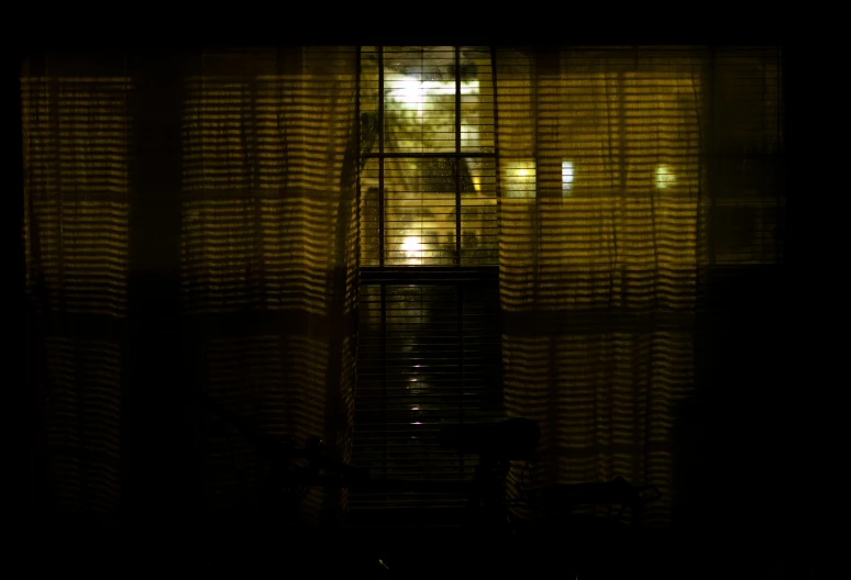 a window with the curtains open and some chairs near it