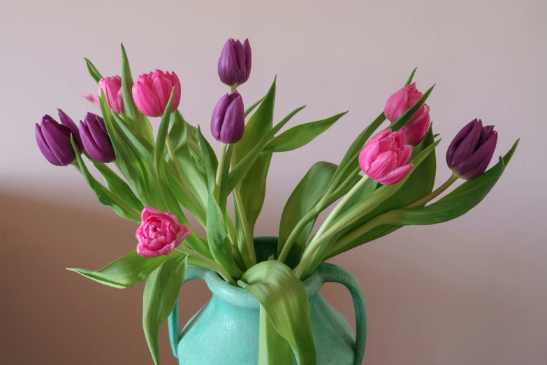 there are many tulips in a blue vase