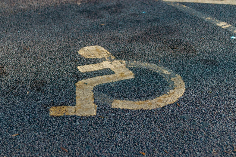 a handicap symbol painted on the ground at an intersection