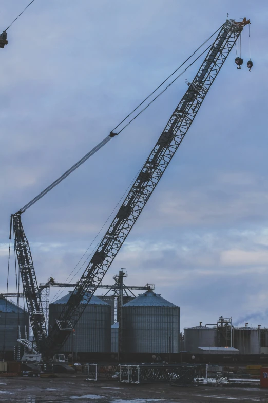 a crane lifting a lot of large silos