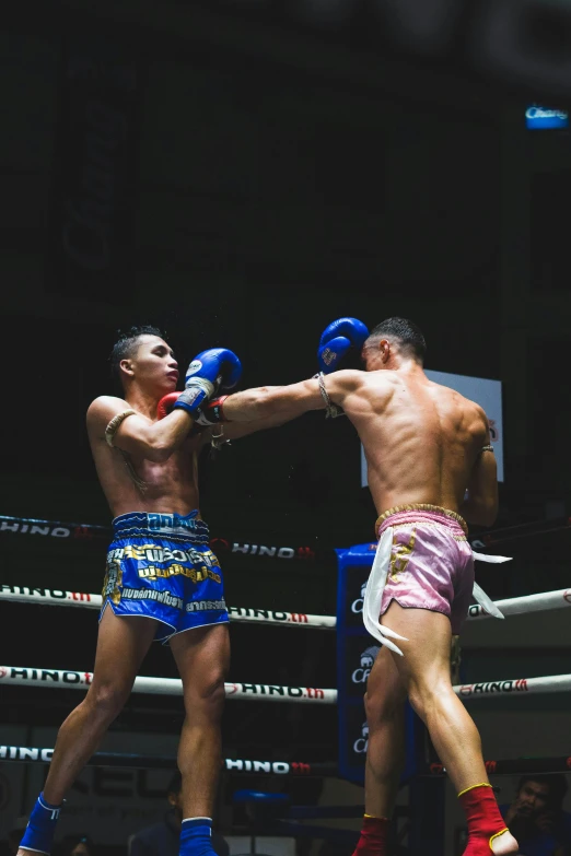 two men boxing in the middle of a competition