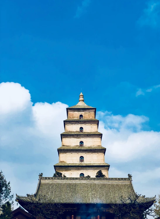 a tall building that is under a blue sky