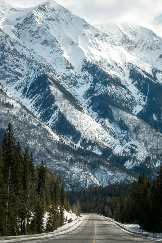 a large long road with mountains in the background