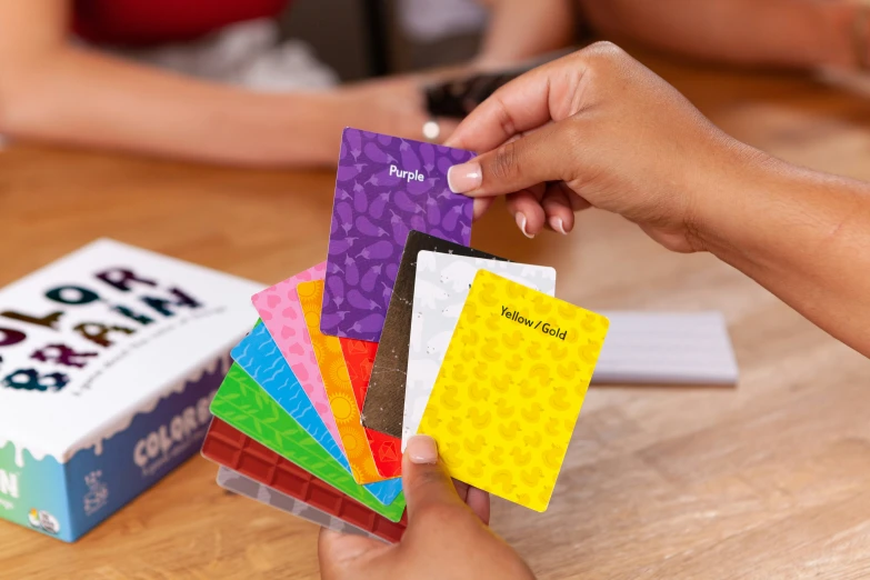 a person handing out a lego card to another hand