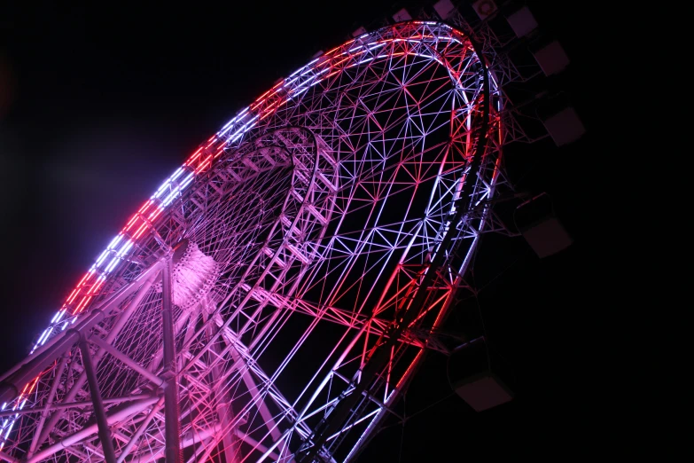 a ferris wheel lit up in the night sky