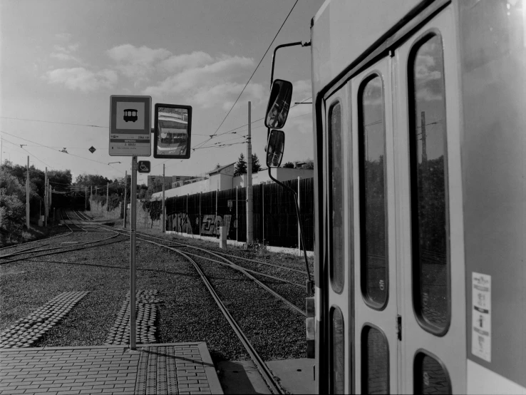 a train traveling past a railway station covered in trees