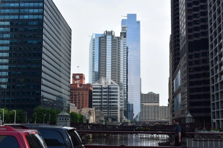 some tall buildings and red trucks and people on the street