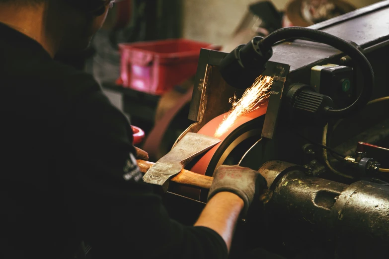 a person is welding some material with a grinder