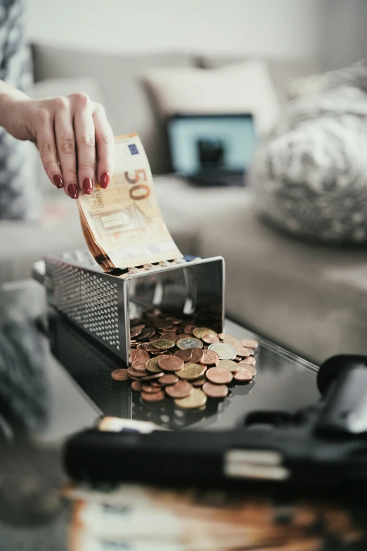 a woman is putting money in a box