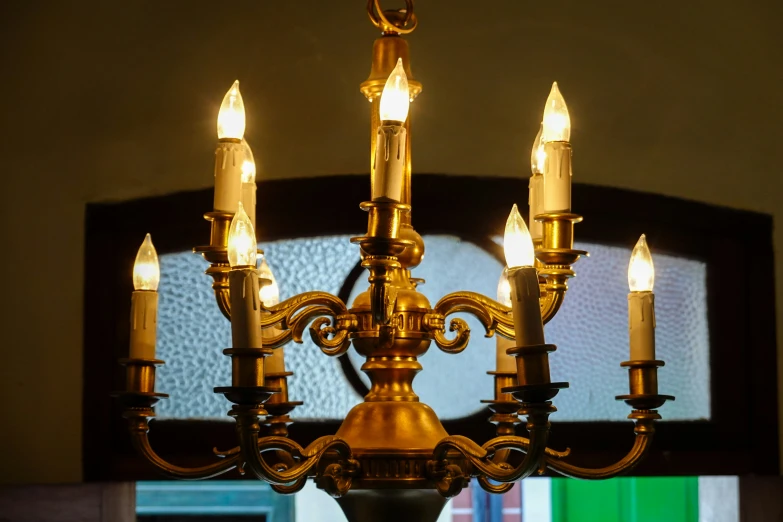 a large chandelier with five lit candles